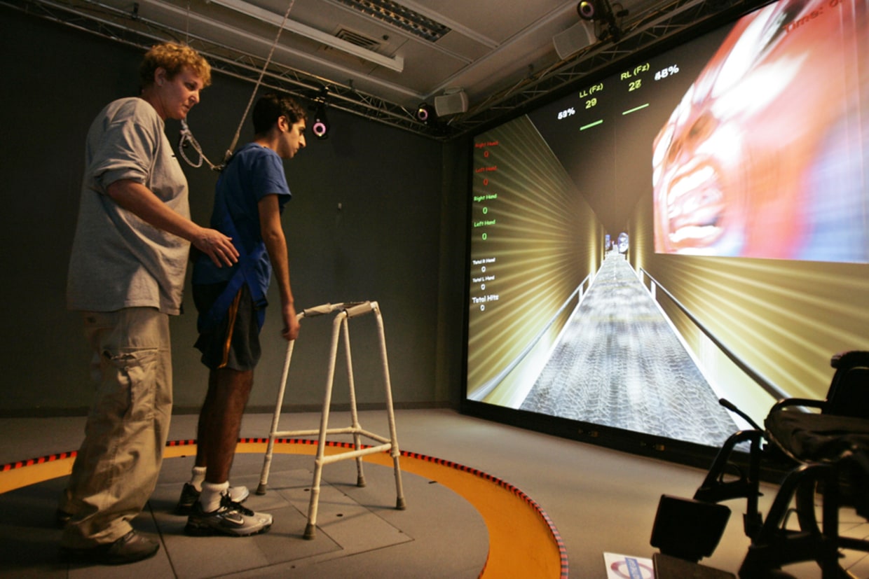 Patient using game-based rehabilitation with therapist support